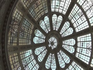 The glass dome of Manchester Victoria station; resembling an ornate spoked wheel with decorative glass in the spaces.